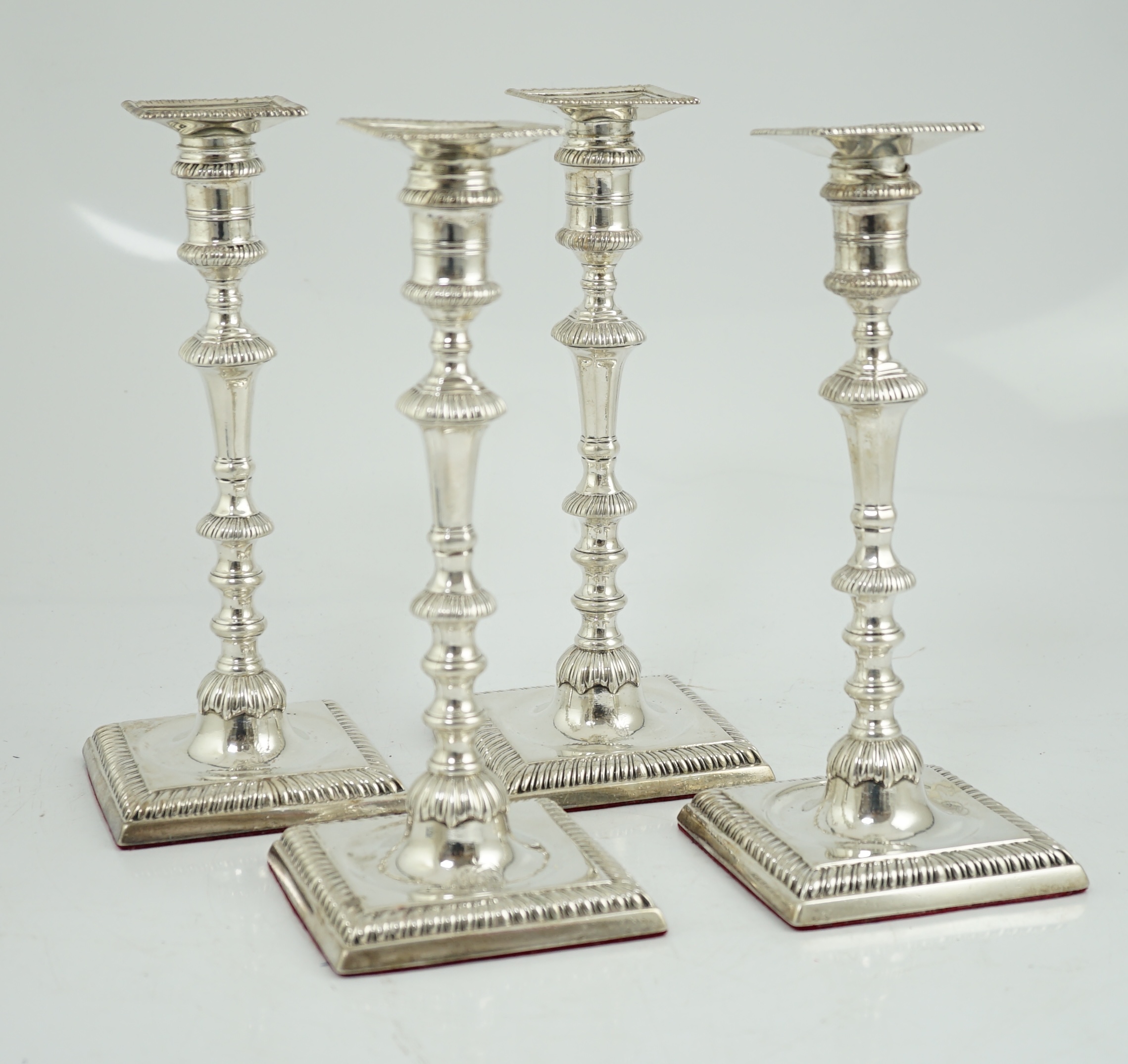 A matched set of four George III silver candlesticks